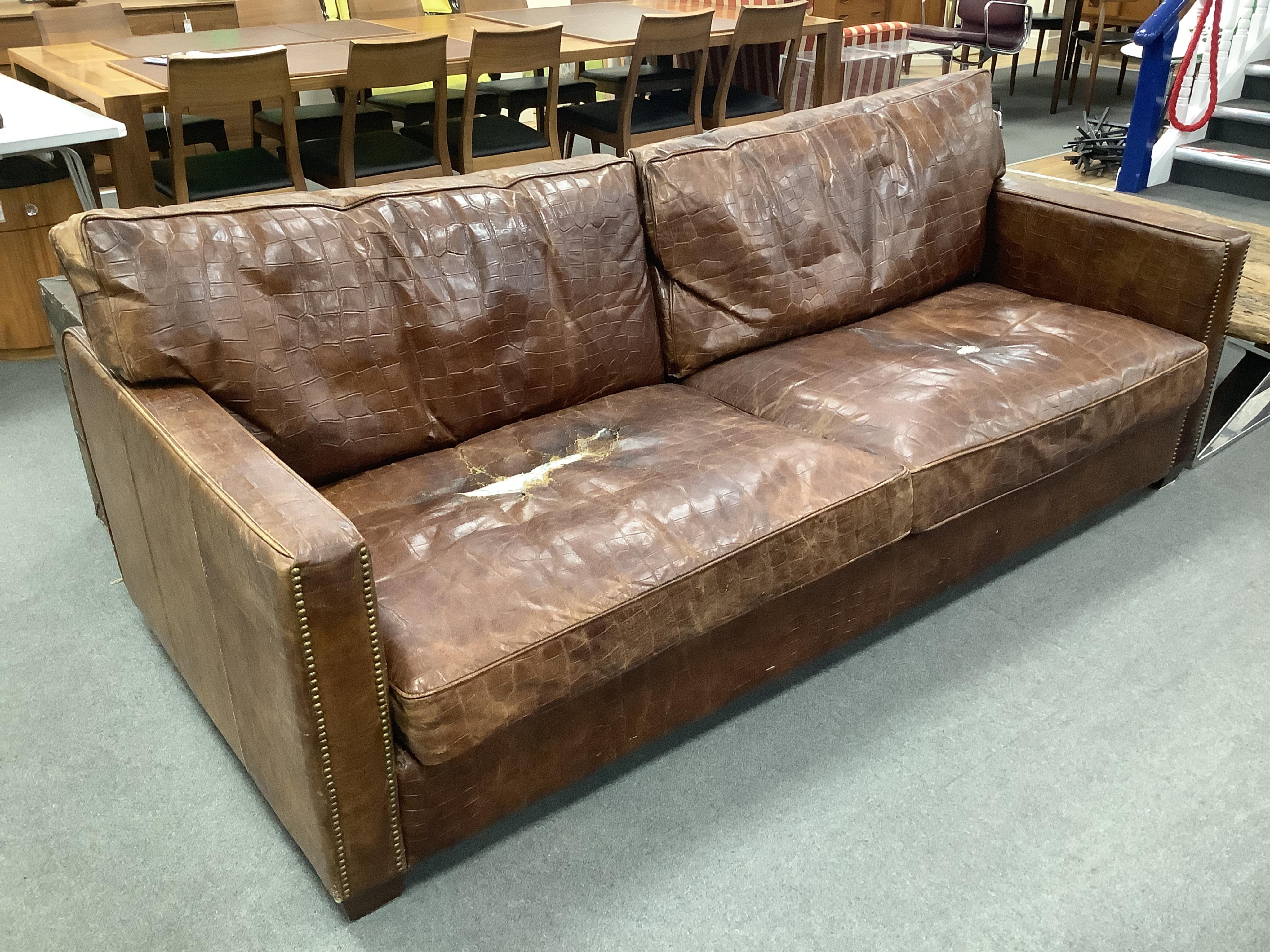 Andrew Martin Viscount William mock crocodile settee by Timothy Oulton with later leather hide covers, width 223cm, depth 98cm, height 88cm. Condition - poor